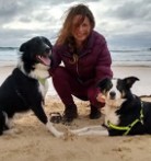 Ann on the beach with two of her dogs on the Isle of Lewis
